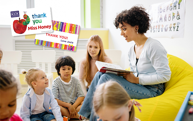 A reception teacher is reading to a group of children